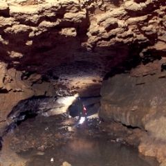 Clarksville cave main tunnel, man in light