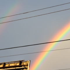 Double rainbow over a billboard